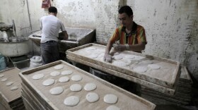Egyptians are seen working in a bakery in Cairo. The U.S. has been working on ways to help revive the economies of nations in transition, like Egypt, Tunisia and Libya, while having limited resources available during tough economic times.