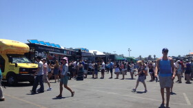 Food lovers check out the gourmet food trucks lined up at the Del Mar Fairgrounds Aug. 15, 2015
