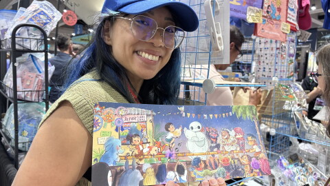 Genevieve Santos poses for a photo while holding up the print she created with Patrick Ballesteros on July 23, 2026.
