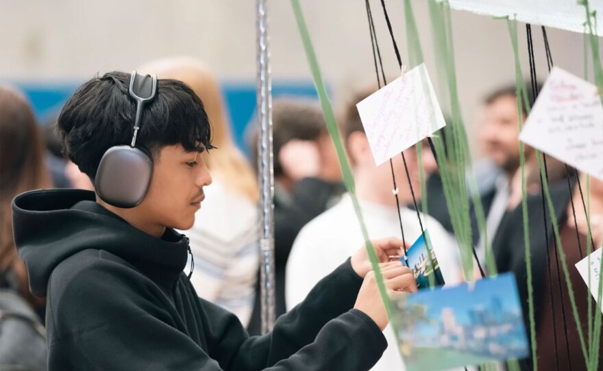 A visitor participates in an interactive art making activity in a previous San Diego Design Week event.