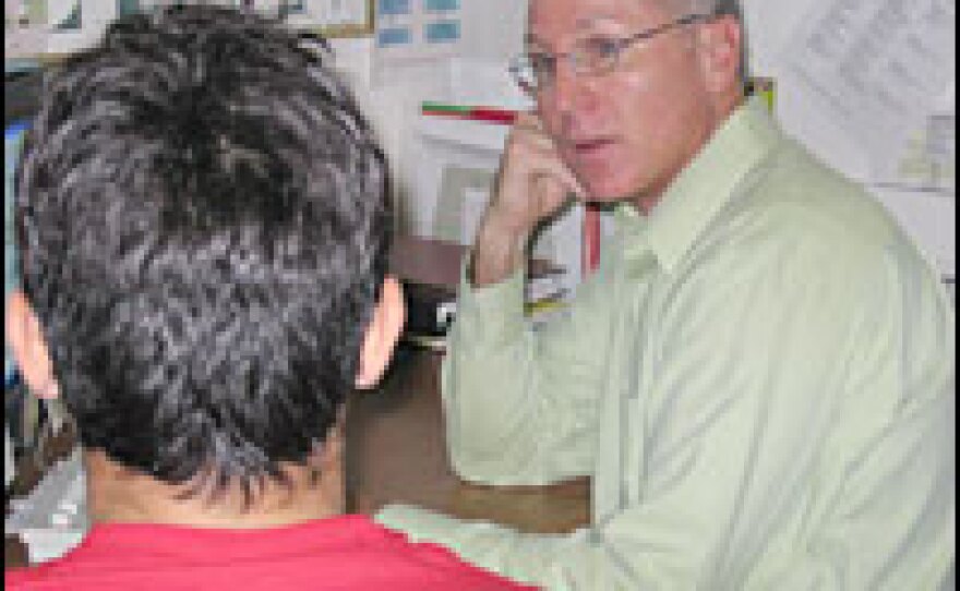 At a Health and Human Services Shelter for migrant children in Chicago, John Muckian (right), a clinician, performs a psychological evaluation of a new arrival from Mexico.