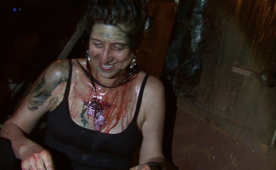 Beth Accomando is covered in fake blood and axle grease after surviving her tour of McKamey Manor, Oct. 3, 2014.