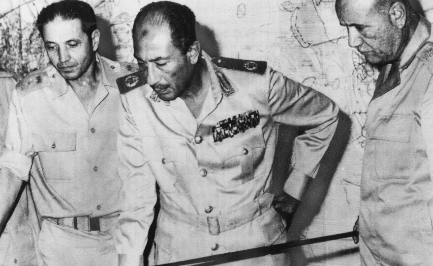 Egyptian President Anwar Sadat is flanked by senior military officers as he reviews maps of battlefield developments in the 1973 Arab-Israeli war. He's shown at army headquarters in Cairo on Oct. 15, 1973. Egypt and Syria attacked Israel, catching Israel and the CIA off-guard.