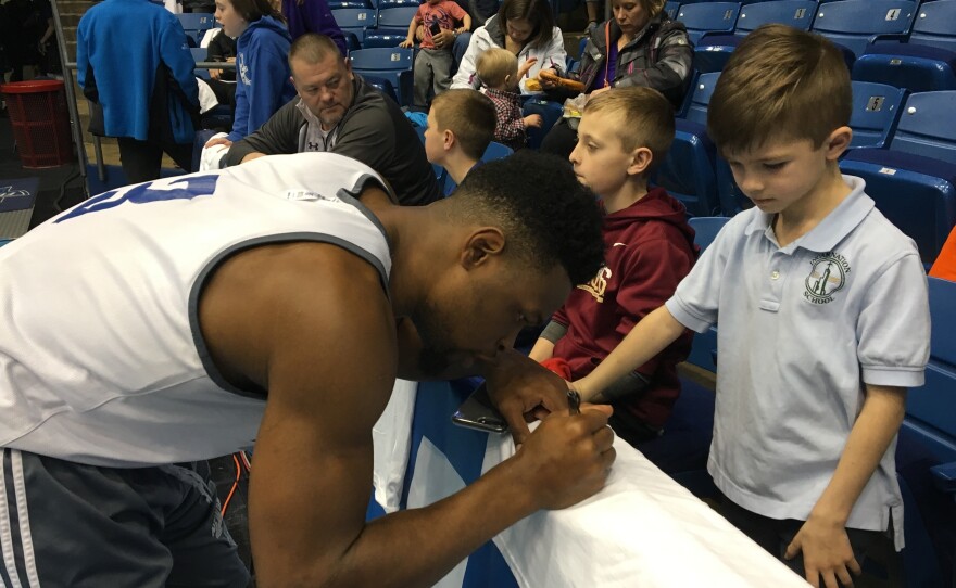 New Orleans Privateer guard Nate Frye signs autographs after a Monday practice at the University of Dayton Arena. Frye, a senior, joined the team when it was going through a difficult period of deciding whether it had the resources to compete in Division I.