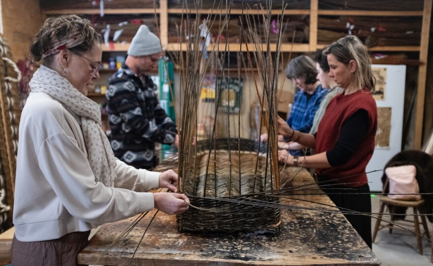 MaddyChristine Hope Brokopp and her friends weave the sides of the burial tray.
