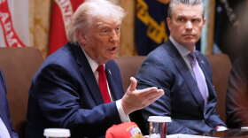 President Donald Trump speaks during a Cabinet meeting at the White House, Wednesday, May 27, 2026, in Washington, as Secretary of Defense Pete Hegseth, looks on.