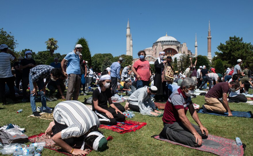 People pray outside Hagia Sophia during the first official Friday prayers since the famous building's conversion from a secular space into a Muslim house of worship.
