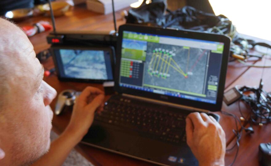 Chris Miser, owner of Falcon UAV, uses a laptop to control and monitor an unmanned aerial vehicle in test flights in May at Olifant West, a private game preserve in South Africa.