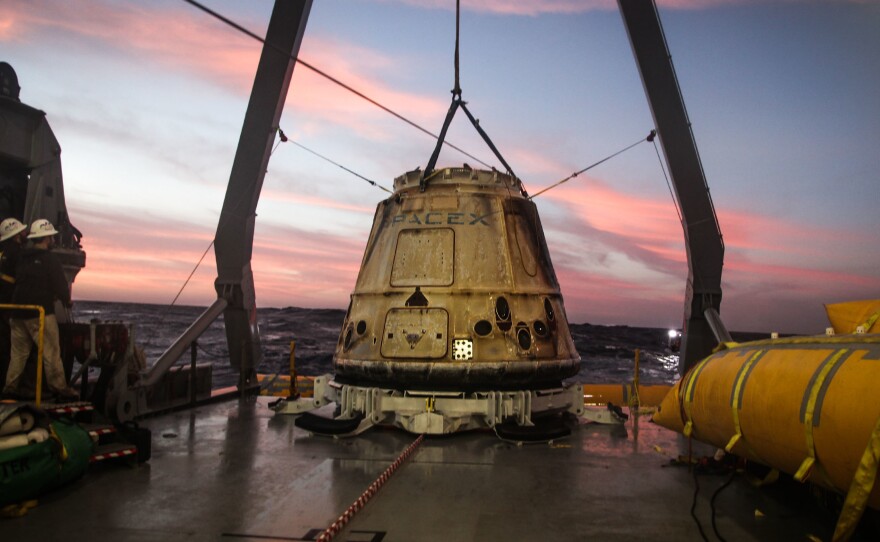 SpaceX regularly flies and returns cargo capsules like the one pictured here to the International Space Station. Now the company says a modified version could take customers to the moon.