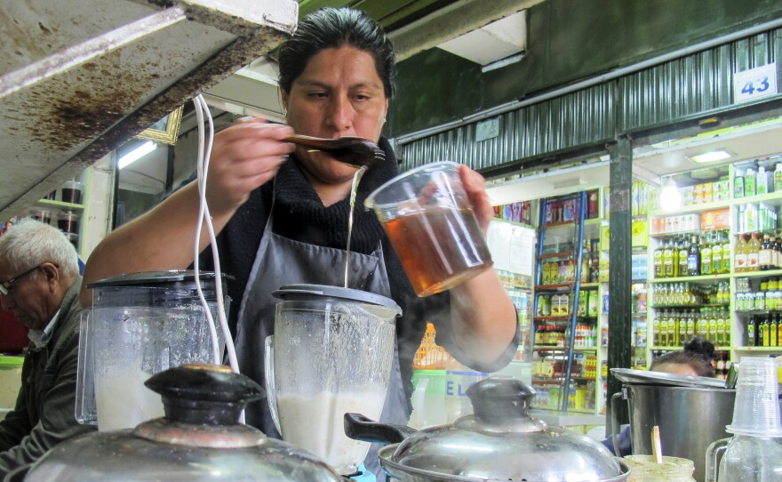 Jackie Rodriguez Peña prepares a frog smoothie at her stand at the Mercado de las Brujas in Lima, Peru.