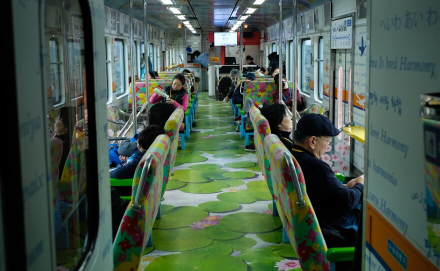 The interior of the DMZ train, a three-car tourist train. It is decorated with words such as "love," "peace" and "harmony," in several languages.