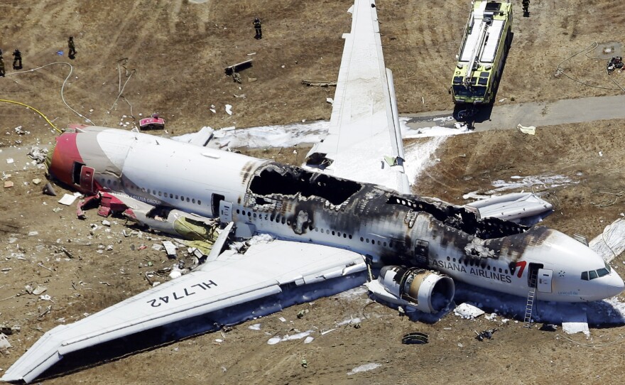 The wreckage of Asiana Flight 214, a Boeing 777 airliner, is seen after it crashed at the San Francisco International Airport Saturday. The crash-landing killed two teenage Chinese girls, the airline says.