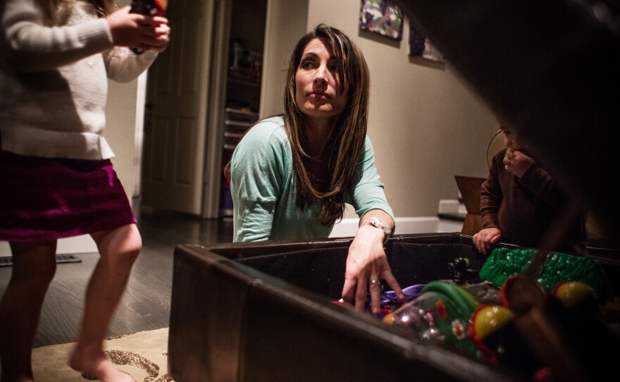 Ashley Moore, a registered nurse who works at a Kaiser Hospital in Walnut Creek, Calif., spends time with her children at home. Moore says to understand why nursing employees get injured, it helps to know the physical demands of the job.