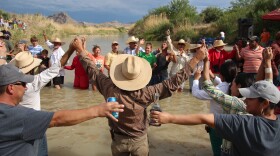 American and Mexican citizens join hands in the Rio Grande. (Photo by Lorne Matalon)