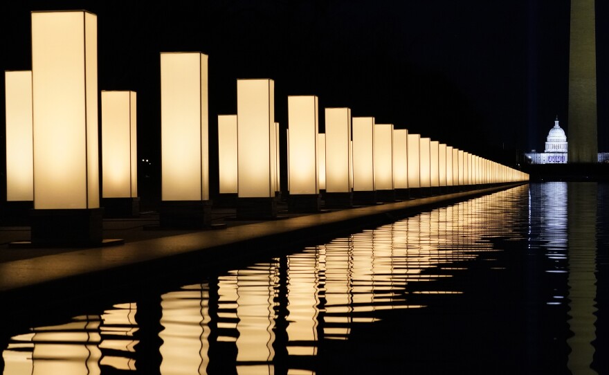 Lights surround the Lincoln Memorial Reflecting Pool, placed as a memorial to COVID-19 victims on Tuesday.