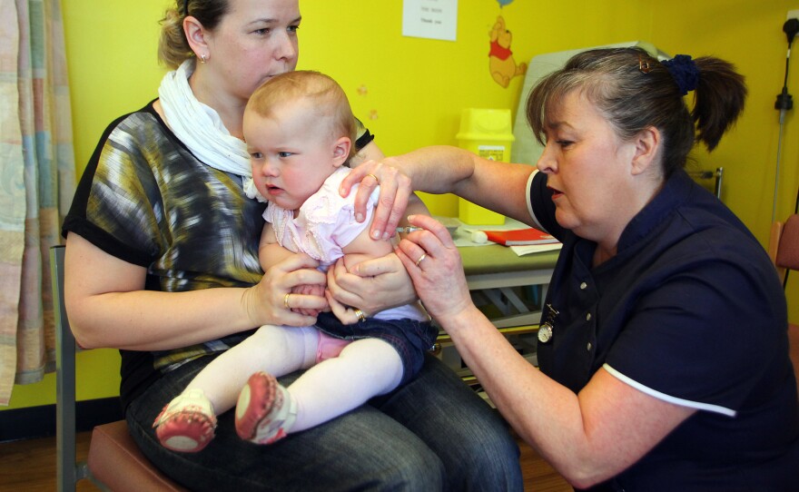 Helen Down holds her 14-month-old daughter, Amelia, for an MMR shot in Swansea, England, in April 2013. The vaccination was in response to a measles outbreak.