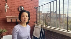 Beata Moon sits on the balcony of her Queens, New York, apartment on December 9, 2021. Because she is not fully vaccinated, much of New York City is off limits to her.