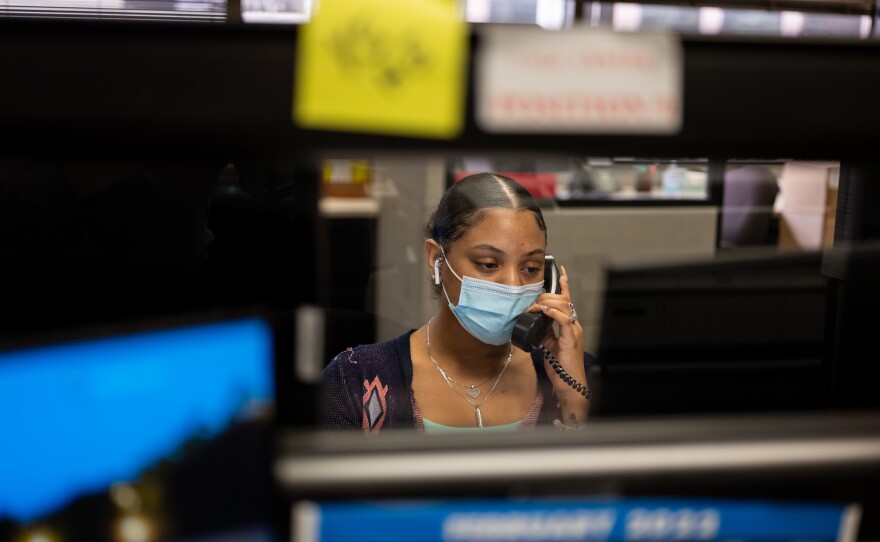 Destiny Laurence receives a call at the Harris County Election Office in downtown Houston. In January alone, Washington and the 14 other workers in the call center received 8,000 calls from people asking for help navigating the voting process.