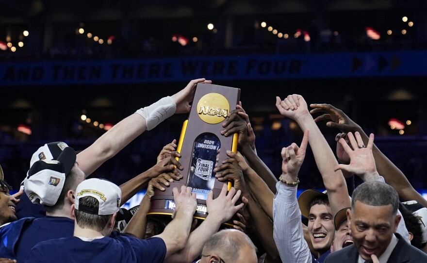UConn players celebrate after the NCAA college Final Four championship basketball game against Purdue, Monday, April 8, 2024, in Glendale, Ariz.