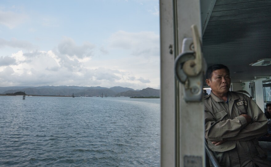 The island of Lombok can be seen in the distance as the ferry continues the four-hour journey from Bali.