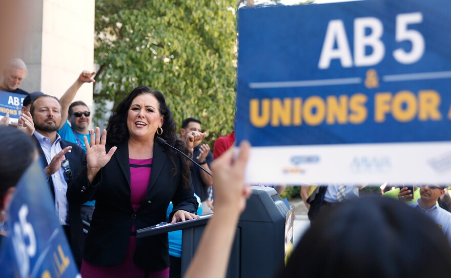 Assemblywoman Lorena Gonzalez, D-San Diego, speaks at a rally after her measure to limit when companies can label workers as independent contractors was approved by a Senate committee, in Sacramento, Calif., Wednesday, July 10, 2019. 