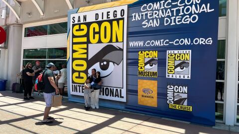 Comic-Con attendees take photos in front of a Comic-Con International sign on July, 23, 2025. 