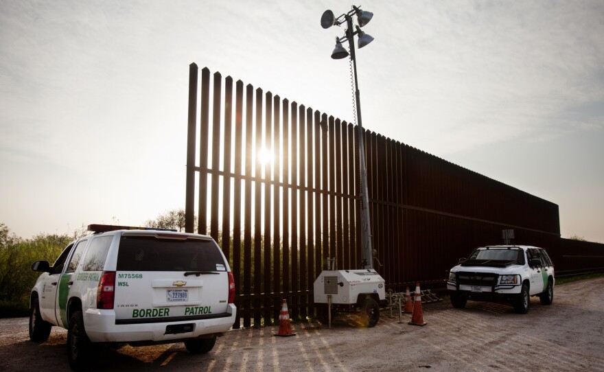 U.S. Border Patrol agents monitor a fence in Hidalgo, Texas, in 2014.