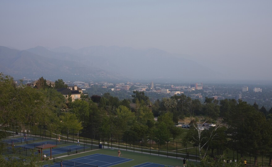 People play tennis amongst the smog in the Salt Lake valley in 2021.