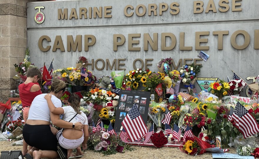People looking at the makeshift memorial at Camp Pendleton in San Diego County, Calif. Aug. 30, 2021.