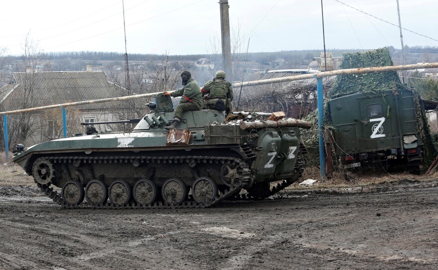 Service members of pro-Russian troops in uniforms without insignia drive an armoured vehicle with the symbol "Z" painted on its side in the separatist-controlled village of Bugas during Ukraine-Russia conflict in the Donetsk region, Ukraine on Sunday.