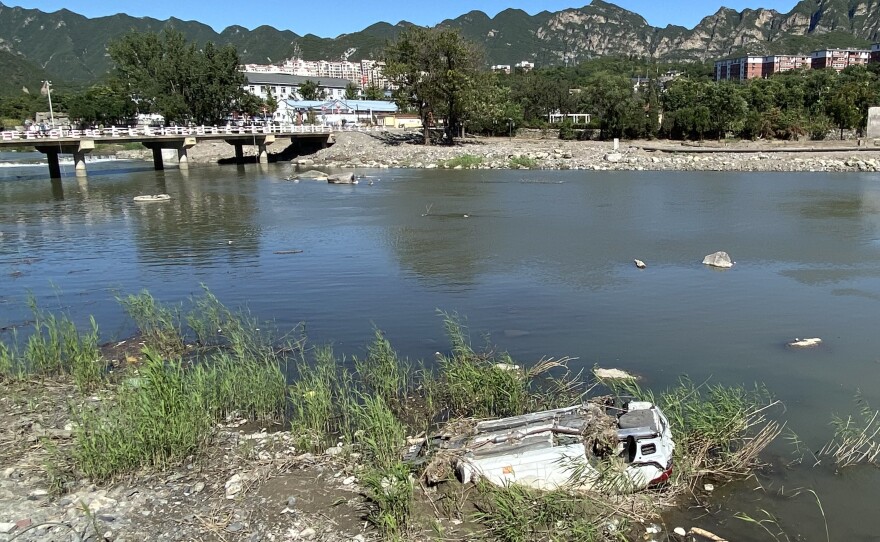 This summer, heavy rains hammered Beijing and the surrounding provinces. An overturned car on a riverbank is a testament to the seriousness of the deluge.
