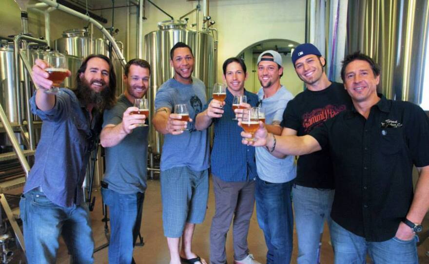 Stone Brewing Co. CEO Greg Koch poses with players from the San Diego Padres over some Operation Homefront IPA — with Greg Koch, Logan Forsythe, Kyle Blanks, John Baker (baseball) and Luke Gregerson at Stone Brewing World Bistro & Gardens - Liberty Station.