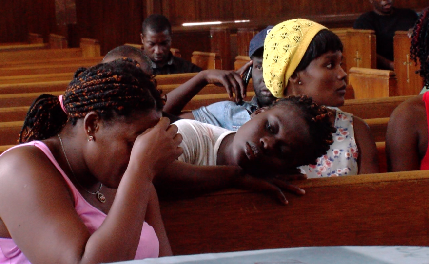 Haitian migrants listen to an improvised service at the United Methodist Christ Ministry Center, July 23, 2016.