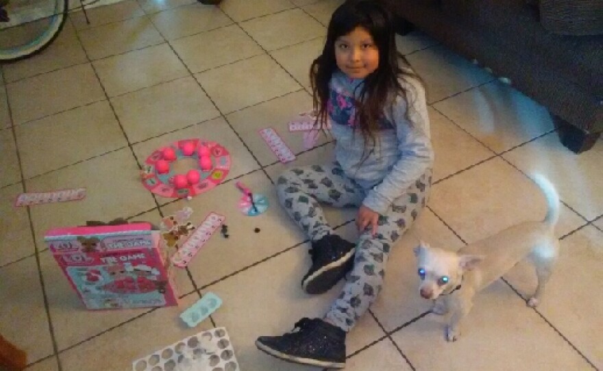 Margarita Diaz's daughter plays on the floor of their City Heights apartment, Feb. 1, 2018.
