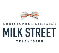 Logo for Christopher Kimball's Milk Street Television series. Title of the series in black letters with a blue and red bowtie above title.