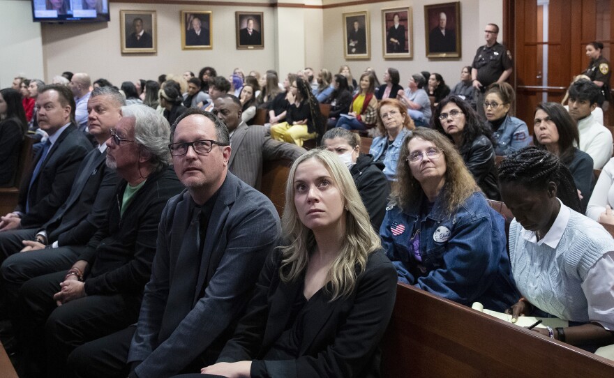 Spectators in court look at monitors in the courtroom at Fairfax County Circuit Court in Fairfax, Va., on Thursday.