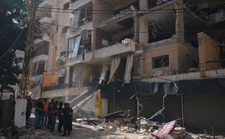 Lebanese security officers gather at the site where an Israeli airstrike hit a building in Dahiyeh, Beirut's southern suburb, Lebanon, Sunday, June 7, 2026.
