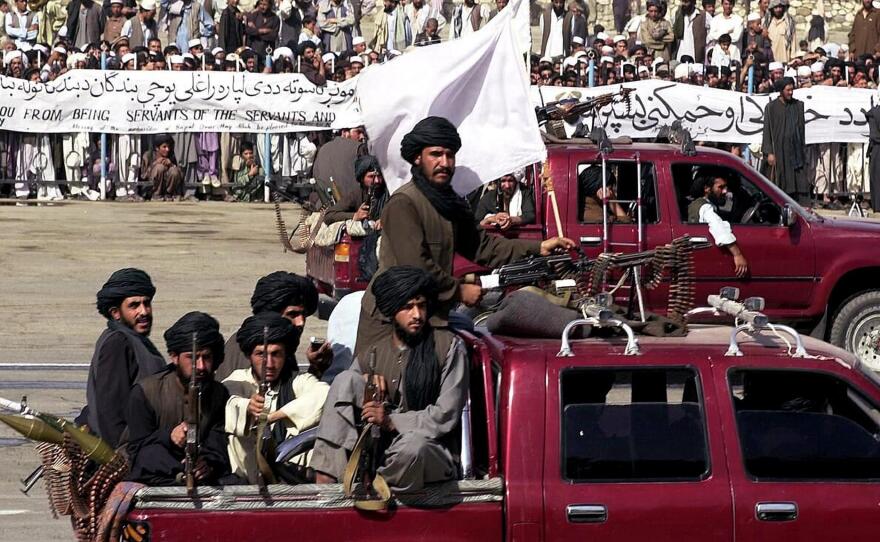 Members of the Taliban militia ride in vehicles during Afghanistan's annual Independence Day parade in Kabul on Aug. 19, 2001. Afghanistan was largely cut off from the world during the Taliban's rule from 1996 to 2001. That changed dramatically after the Sept. 11 attacks.