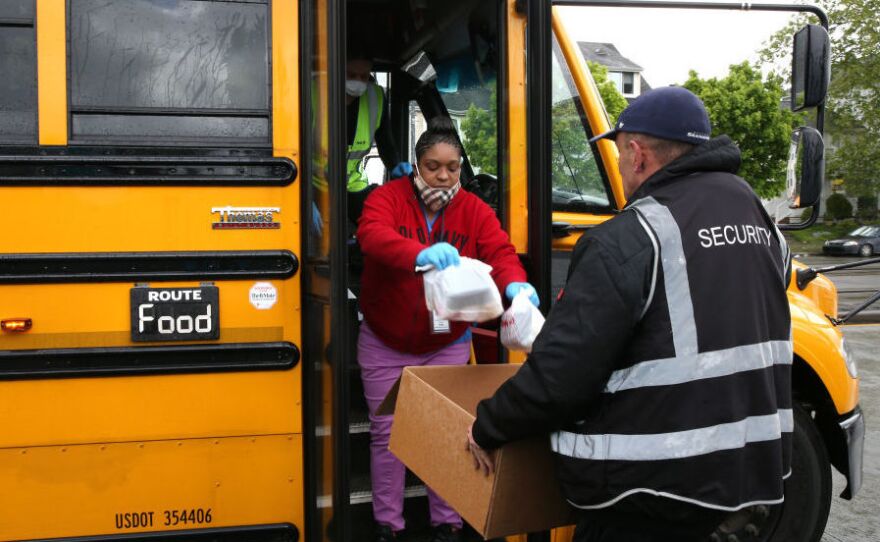Nutritionist Shaunté Fields and bus driver Treva White, left, deliver meals to children and their families in Seattle. When schools closed because of COVID-19, Seattle Public Schools began distributing breakfast and lunch to students through a network of 26 school sites and 43 bus routes five days a week.
