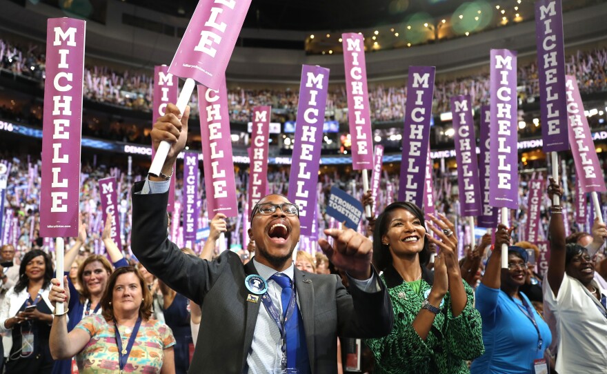 Delegates stand and cheer as first lady Michelle Obama speaks on the first day of the Democratic National Convention.