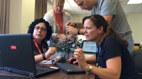 High School teachers Christine Hill, Teresa Dunlap, Carol Bonn and another Project Lead the Way participant work to get their rover-style robot's arm to lift, June 30, 2016. San Diego State University offers Project Lead the Way engineering training each summer to teachers.