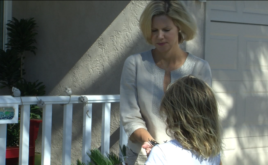 Katherine Faulconer talks with her daughter Lauren outside their Point Loma home.