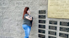 Lupita Garcia looks at the plaque with her son's name at a memorial in Montebello, California.