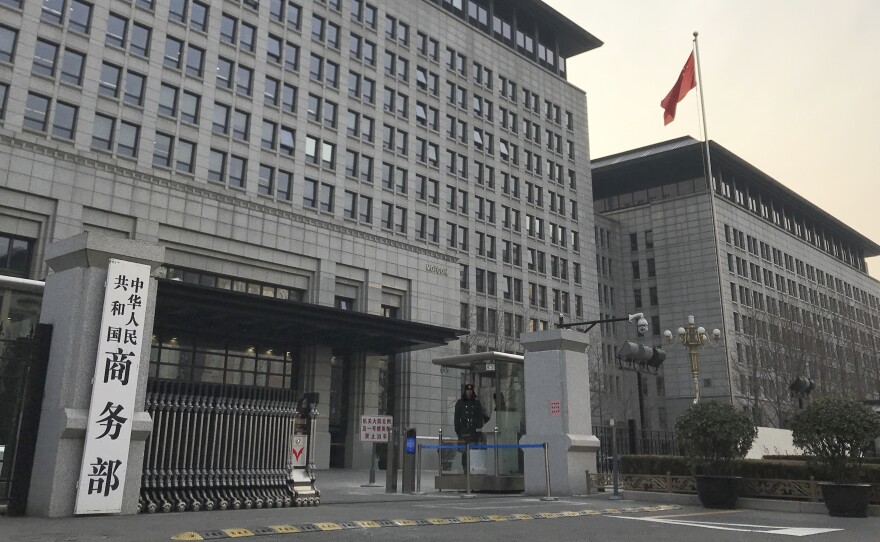 U.S. and Chinese envoys extended trade talks into a third day Wednesday after President Trump said negotiations aimed at ending a tariff war were "going very well!"