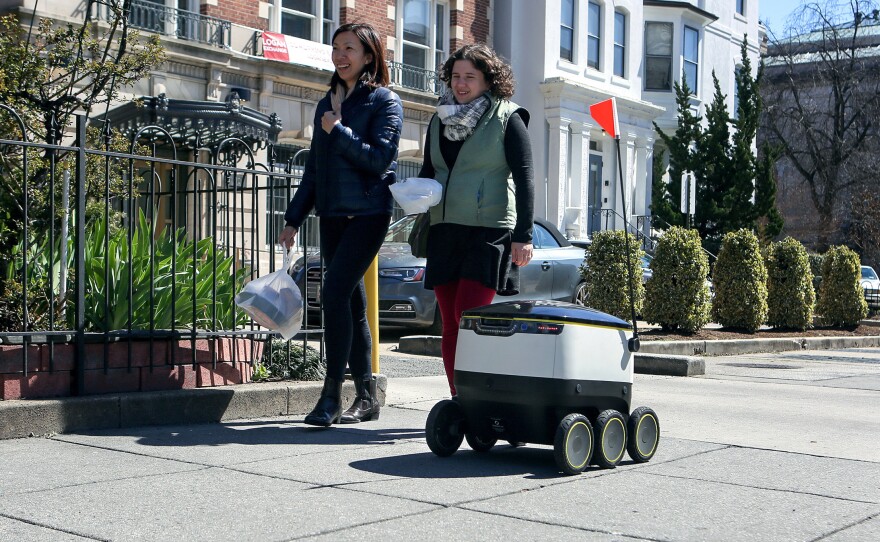 The delivery bot zips its way down a Washington, D.C., sidewalk during a demonstration of the autonomous machine.