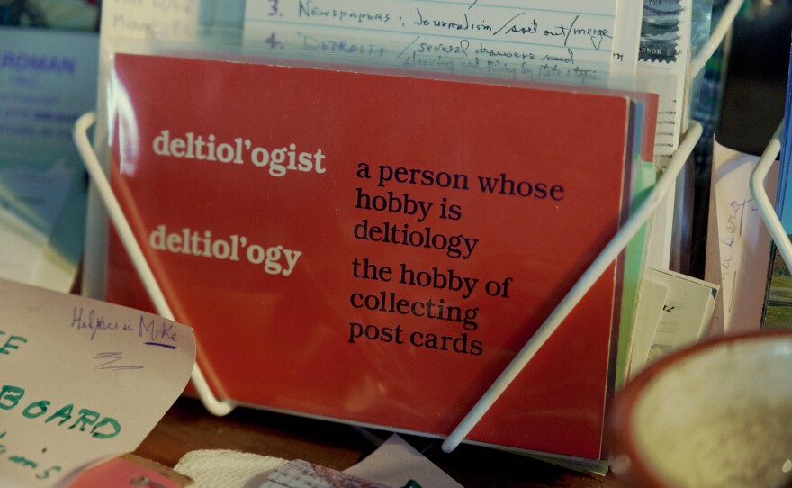 A postcard containing the definition of deltiology sits inside Brown's home.