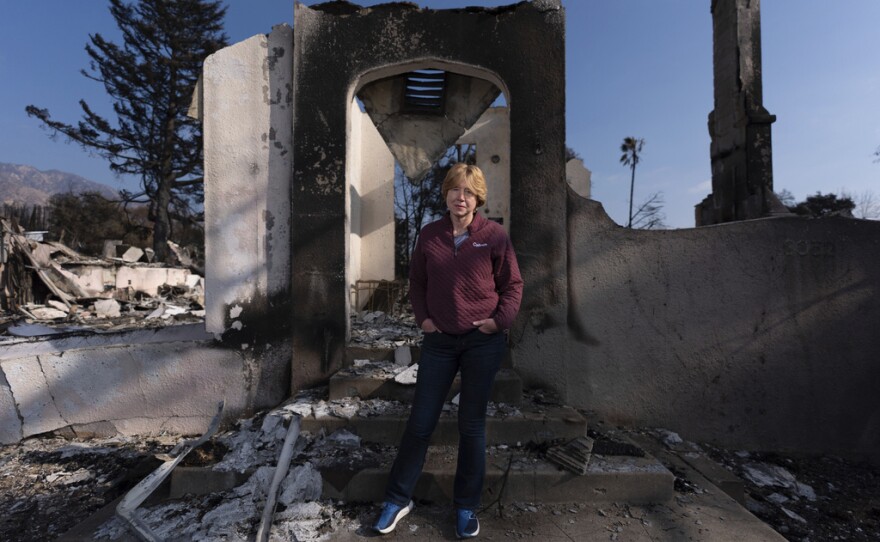 Louise Hamlin stands for a photo in front of her home ravaged by the Eaton Fire in Altadena, Calif., Thursday, Jan. 30, 2025.