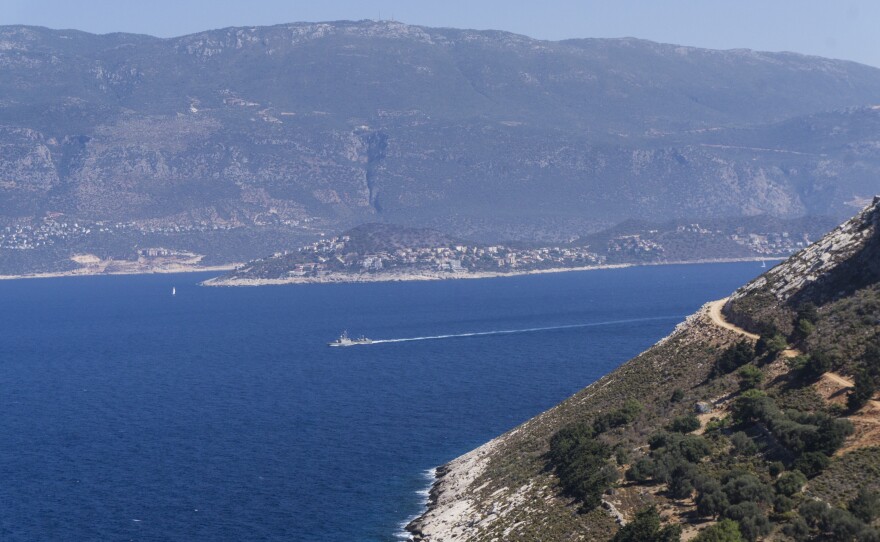 A Greek military ship glides along the stretch of sea between Kastellorizo and the neighboring Turkish town of Kas.