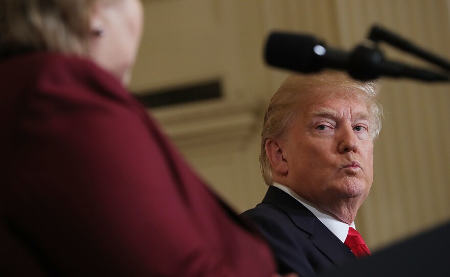 President Trump listens as Norwegian Prime Minister Erna Solberg speaks at a joint news conference Wednesday. At an Oval Office meeting on immigration policy, Trump said the U.S. should want more people from countries like Norway, disparaging Haiti and what he called "shithole countries" in Africa.