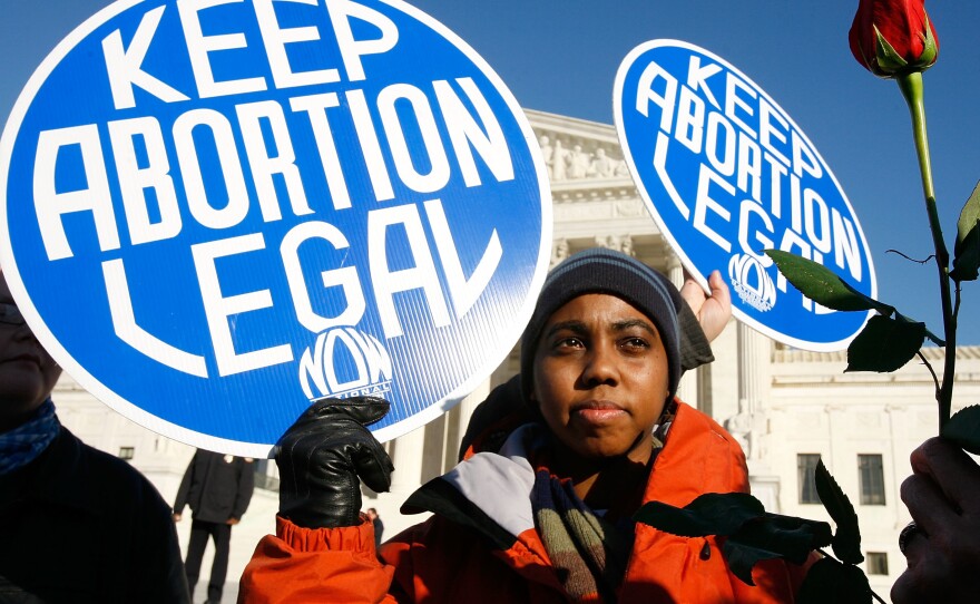 Pro-choice activist Lisa King holds a sign in front of the U.S. Supreme Court.